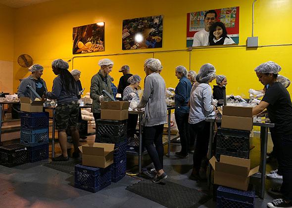 Volunteers pack bags of rice at the San Francisco Food Bank.
